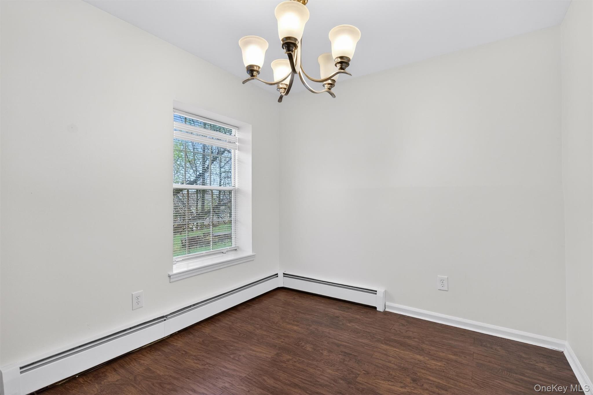 5 Lexington Hills Road, Unit 1 Harriman, NY 10926 - Photo 7 of 29 a view of an empty room with wooden floor and a window