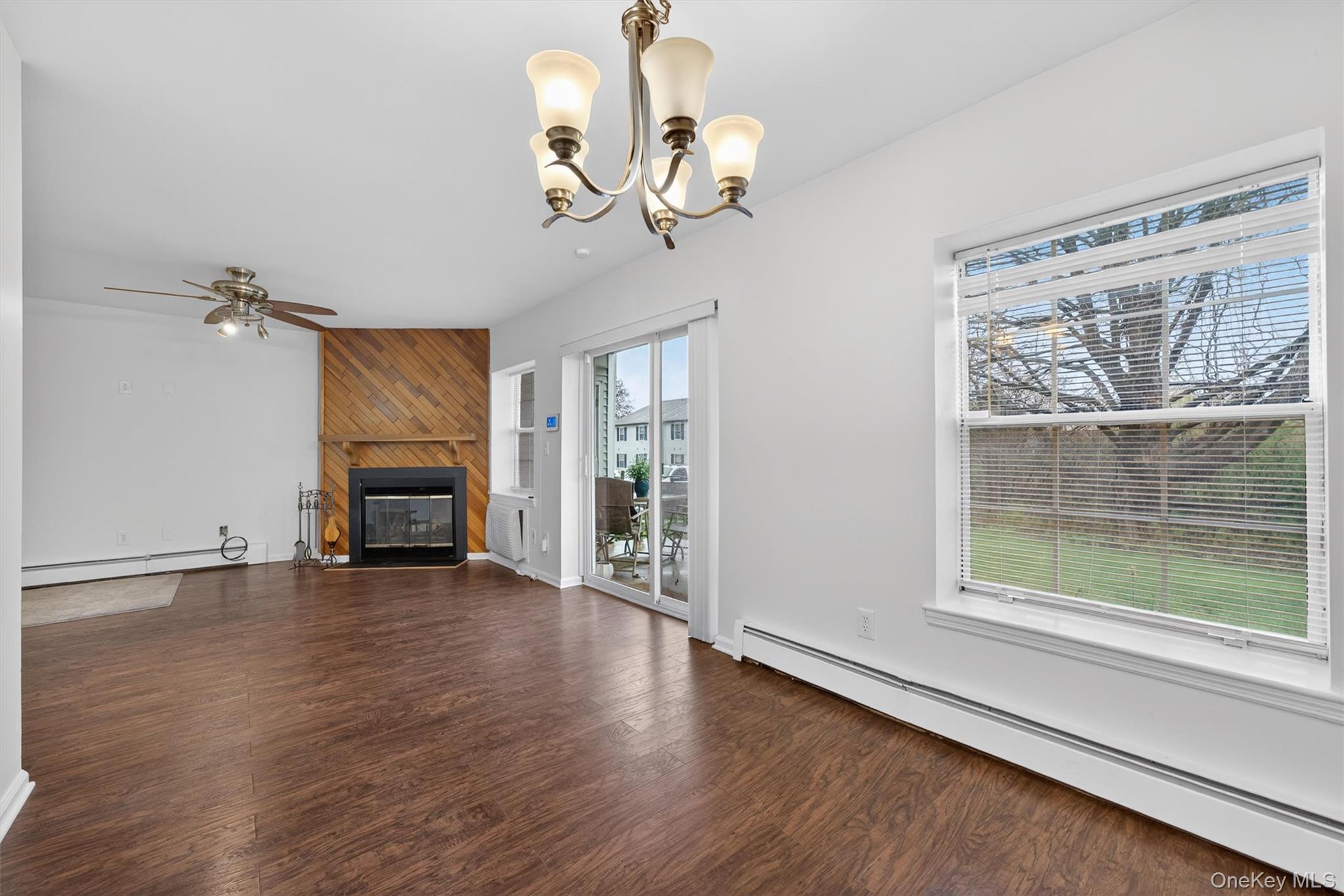 5 Lexington Hills Road, Unit 1 Harriman, NY 10926 - Photo 8 of 29 a view of a livingroom with wooden floor a ceiling fan and windows