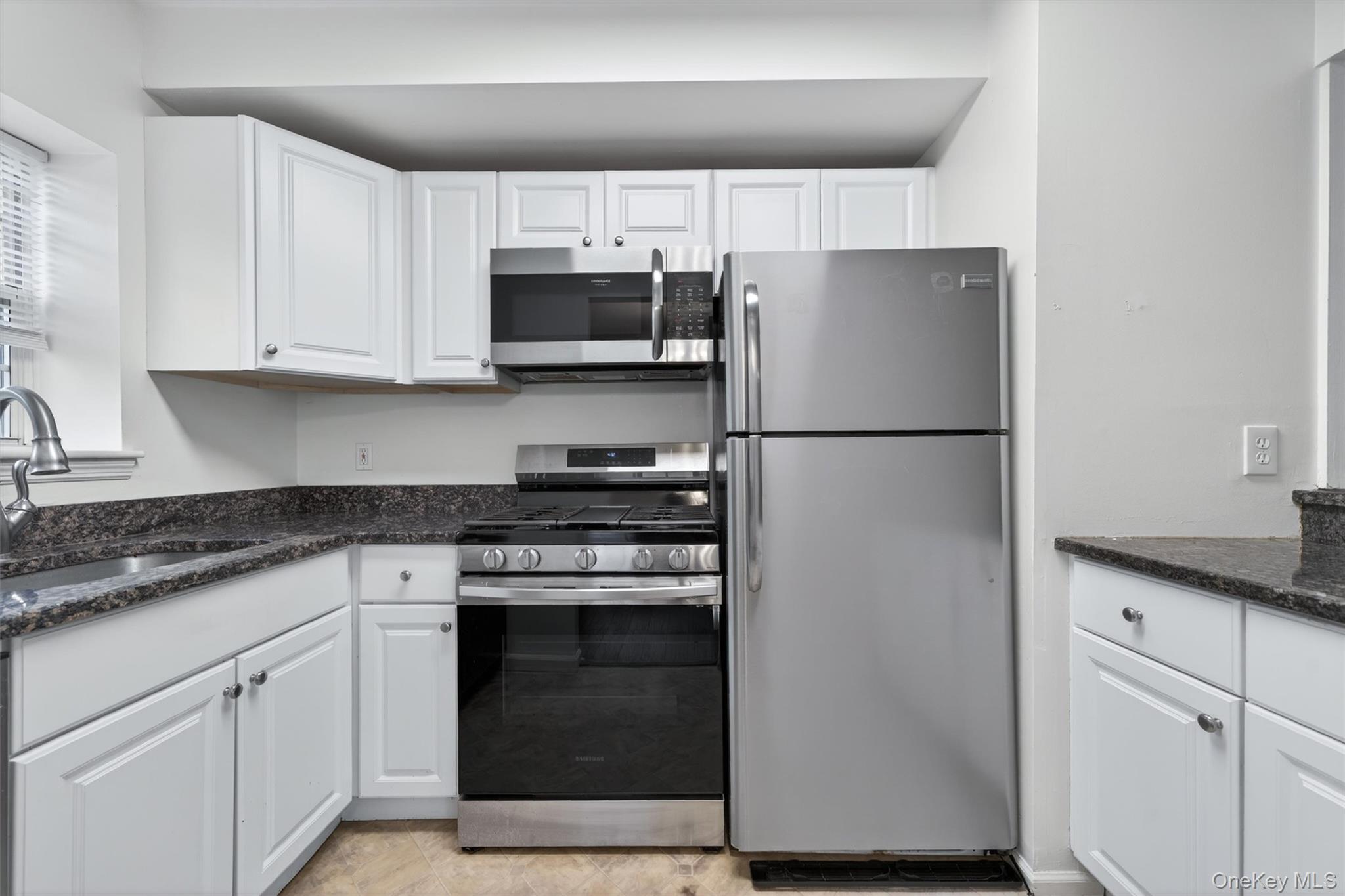 5 Lexington Hills Road, Unit 1 Harriman, NY 10926 - Photo 10 of 29 a kitchen with cabinets stainless steel appliances and sink
