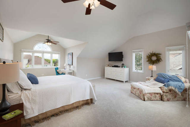 1572 White Eagle Drive Naperville, IL 60564 - Photo 15 of 33 a bedroom with bed and a chandelier