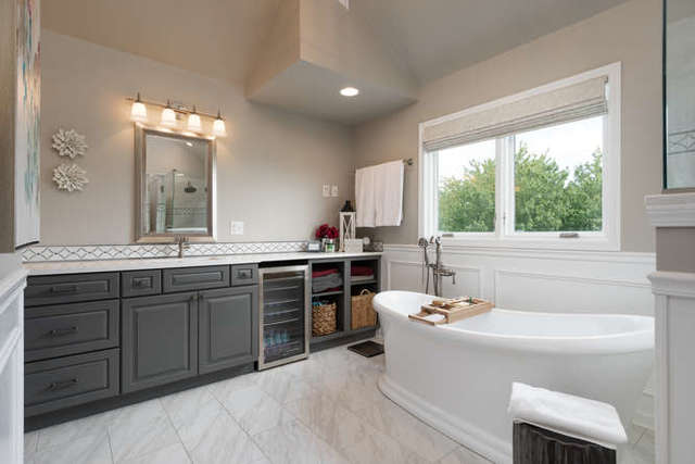 1572 White Eagle Drive Naperville, IL 60564 - Photo 18 of 33 a bathroom with a tub a sink and a large mirror