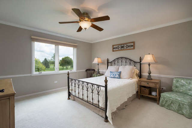 1572 White Eagle Drive Naperville, IL 60564 - Photo 22 of 33 a bedroom with a bed chandelier and a window