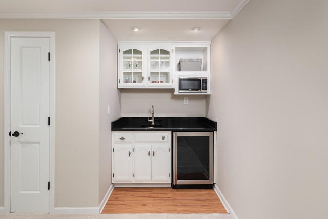 1572 White Eagle Drive Naperville, IL 60564 - Photo 25 of 33 a kitchen with stainless steel appliances granite countertop a sink and a stove with wooden floor