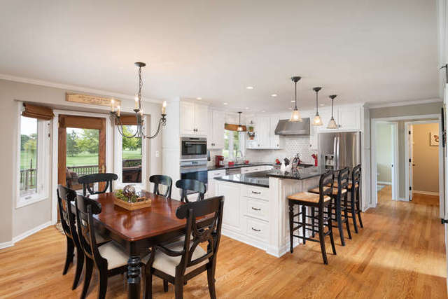 1572 White Eagle Drive Naperville, IL 60564 - Photo 9 of 33 a view of a dining room with furniture and wooden floor