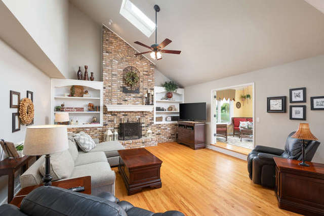 1572 White Eagle Drive Naperville, IL 60564 - Photo 10 of 33 a living room with fireplace furniture and a flat screen tv