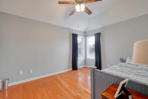 a living room with furniture and a ceiling fan