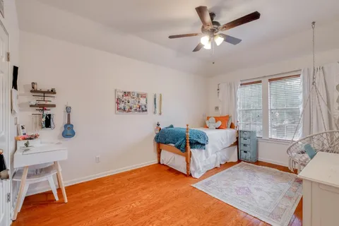 a bedroom with a bed and a chandelier