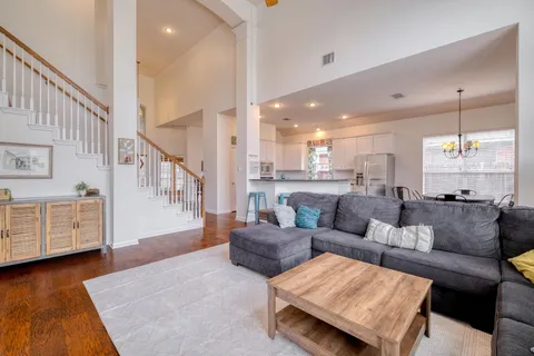 a living room with furniture and wooden floor