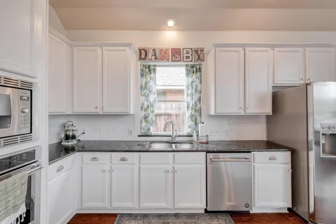 a kitchen with appliances cabinets and a sink