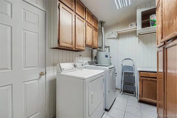 a utility room with cabinets washer and dryer