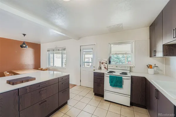 a kitchen that has a sink and a stove in it