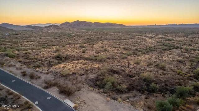 a view of mountains in middle of a field