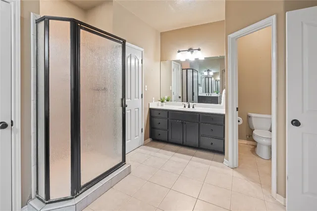 a bathroom with a double vanity sink toilet and shower