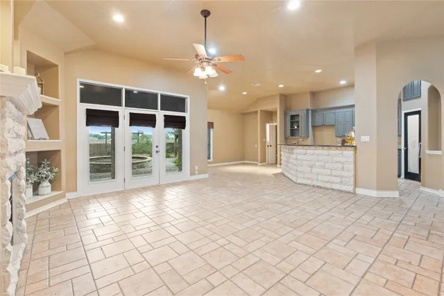 a view of an empty room with a kitchen