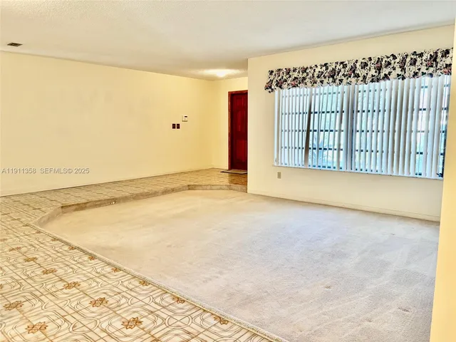 a kitchen with white cabinets and appliances