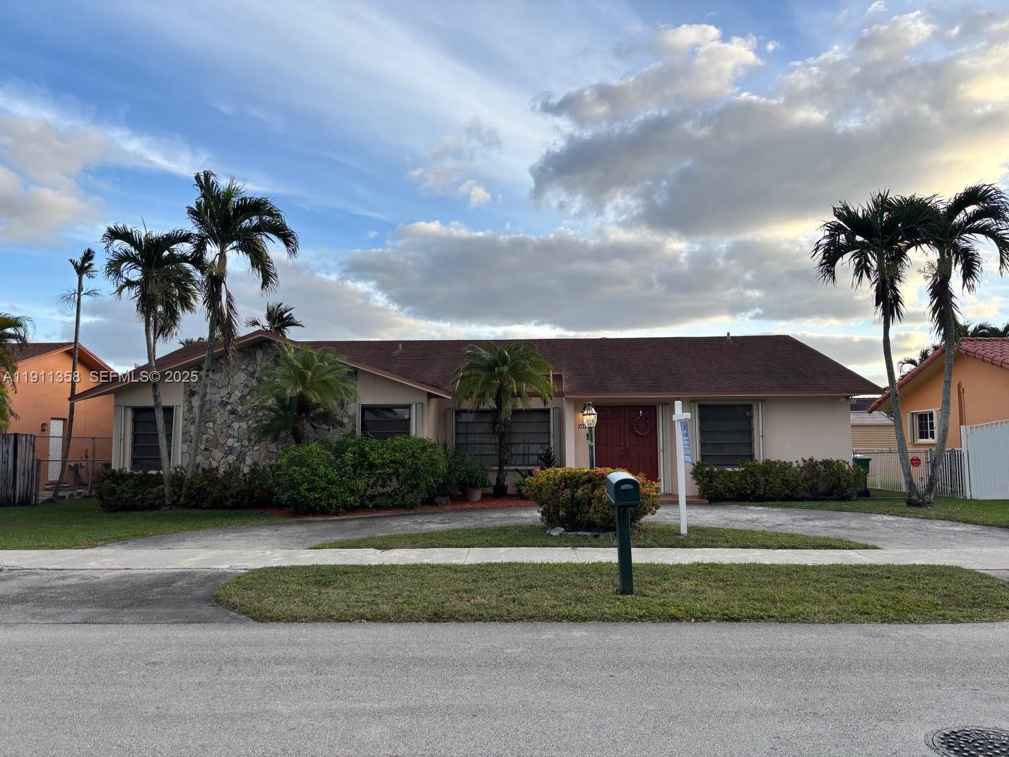 9730 Southwest 5th Street Miami, FL 33174 - Photo 2 of 37 a front view of a house with a garden