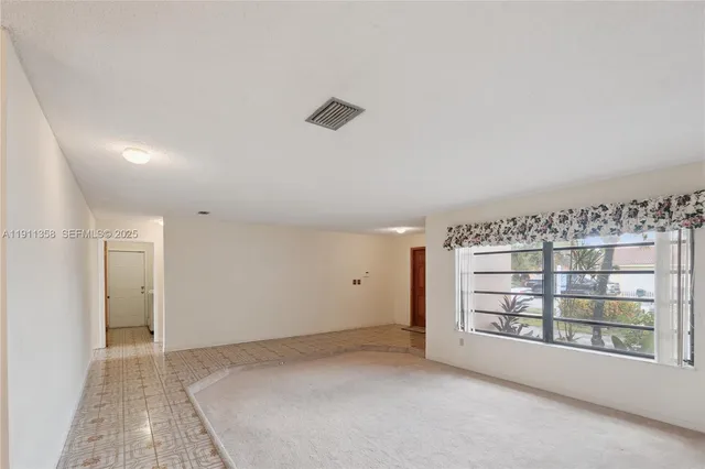 a kitchen with cabinets and window
