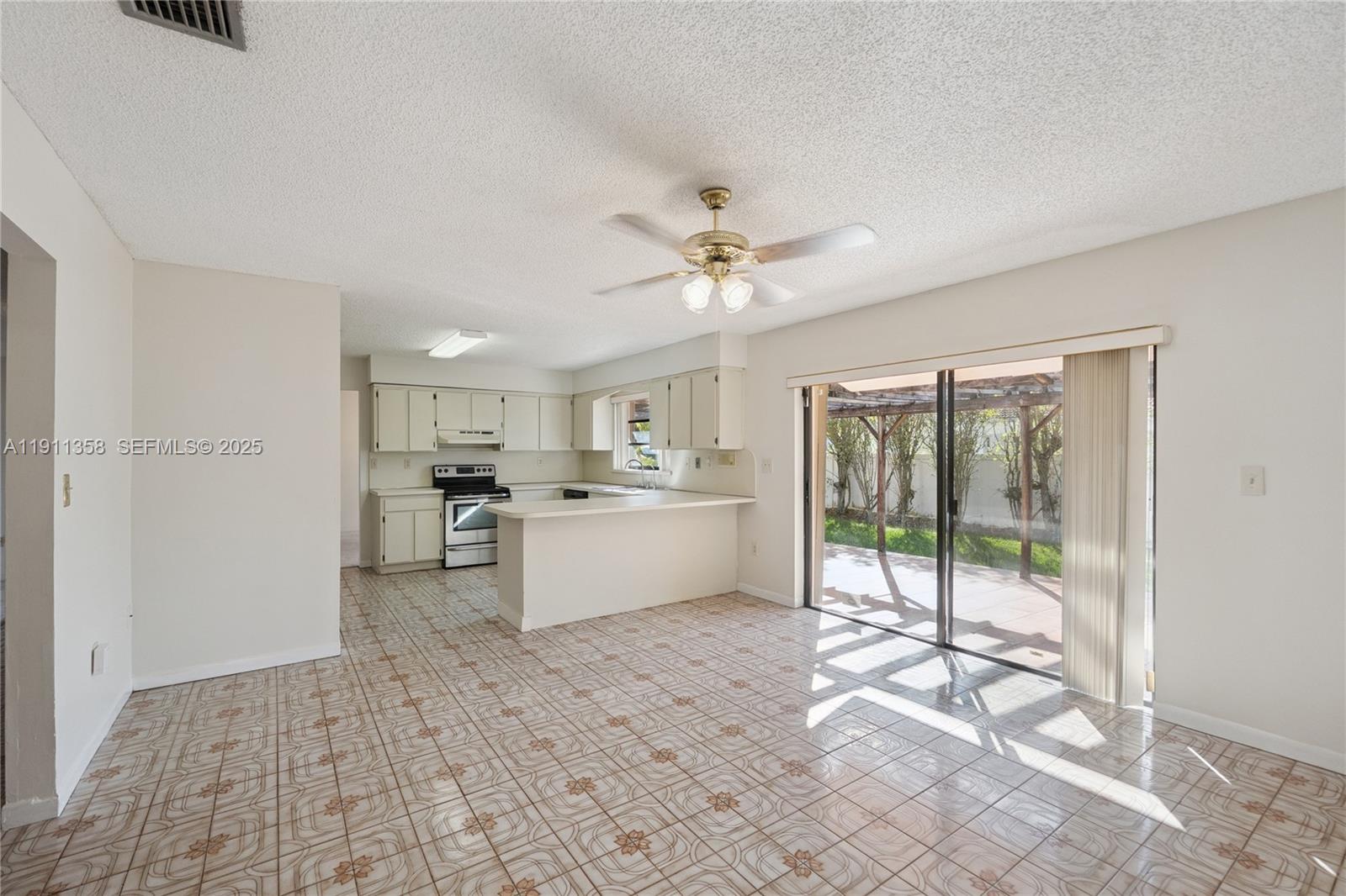 9730 Southwest 5th Street Miami, FL 33174 - Photo 25 of 37 a open kitchen with white cabinets and white appliances