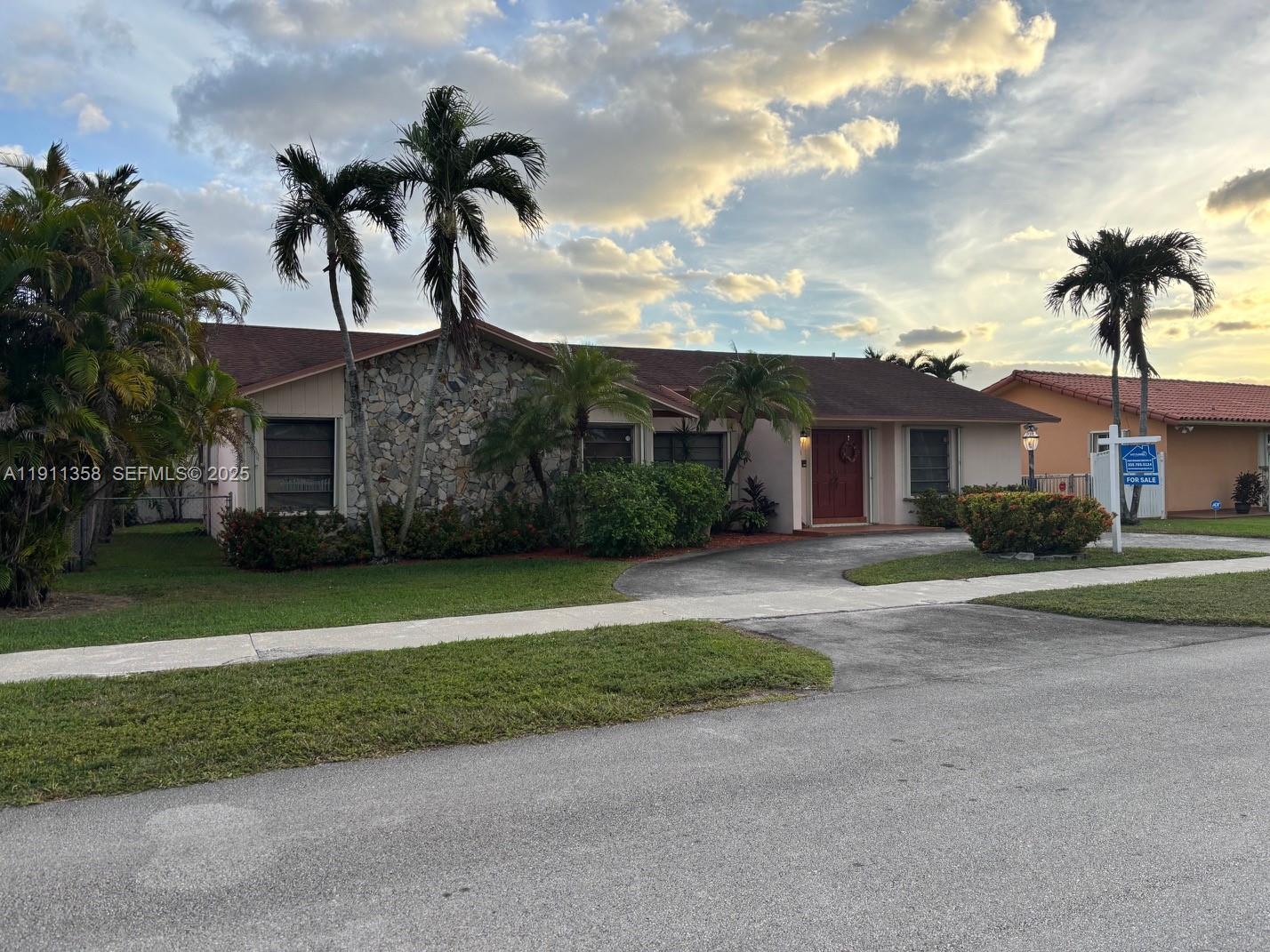 9730 Southwest 5th Street Miami, FL 33174 - Photo 3 of 37 a front view of a house with a garden and yard
