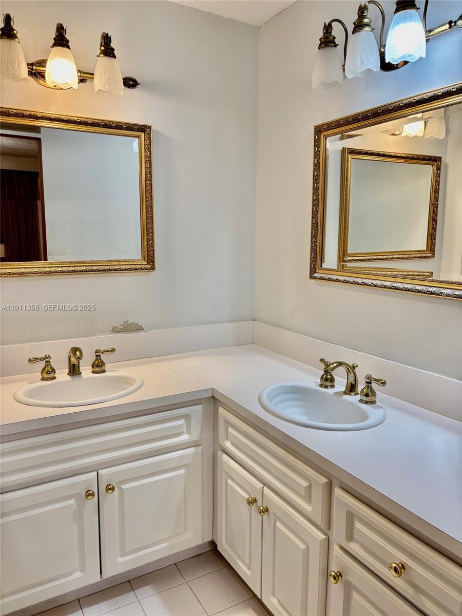 9730 Southwest 5th Street Miami, FL 33174 - Photo 32 of 37 a bathroom with mirror a sink and vanity