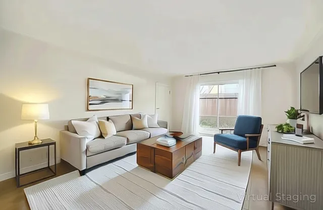 a living room with furniture and wooden floor