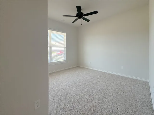a view of an empty room and a window