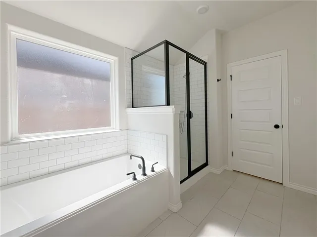 a bathroom with a bathtub and a shower