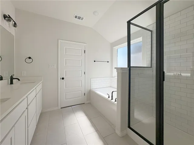 a bathroom with a shower and a sink