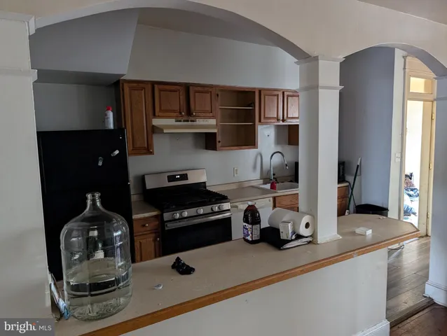 a kitchen with a stove and a refrigerator