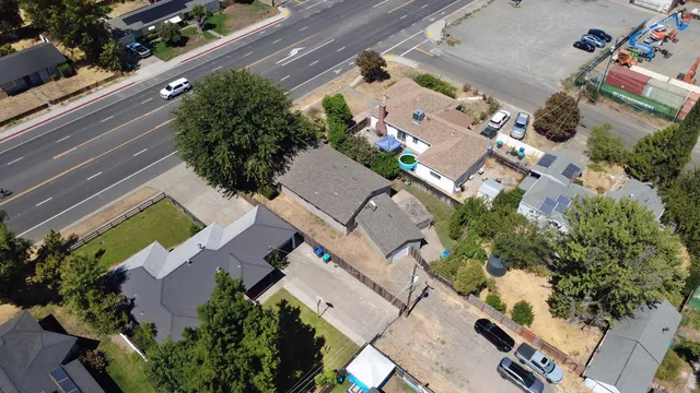 an aerial view of a house with a yard