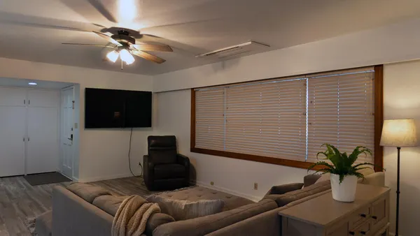 a bedroom with furniture and a potted plant