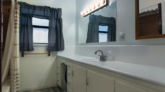 a bathroom with a sink a vanity and a mirror