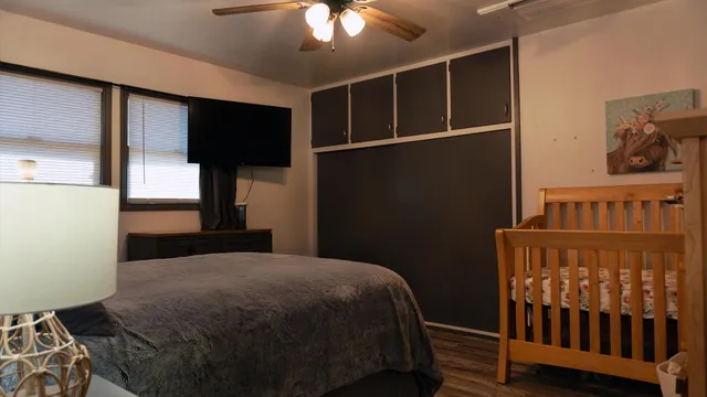 a bedroom with a bed and wooden floor
