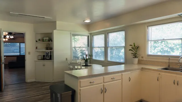 a spacious bathroom with a sink mirror and a window