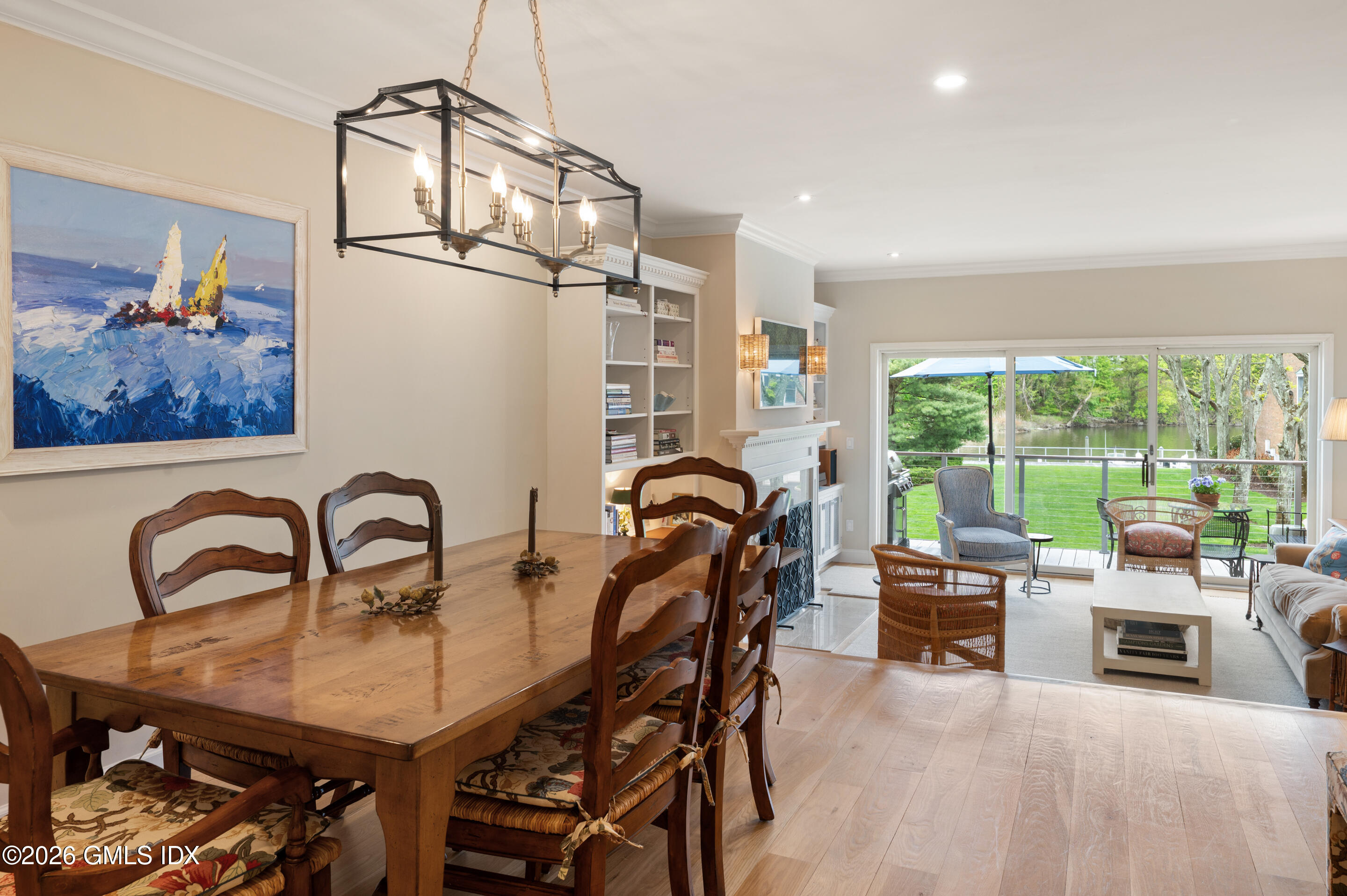 115 River Road, Unit 3 Cos Cob, CT 06807 - Photo 10 of 40 a dining room with furniture a chandelier and a rug