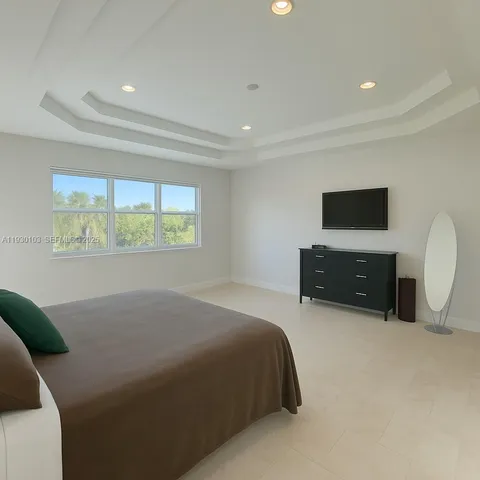 a bed room with a bed and a television