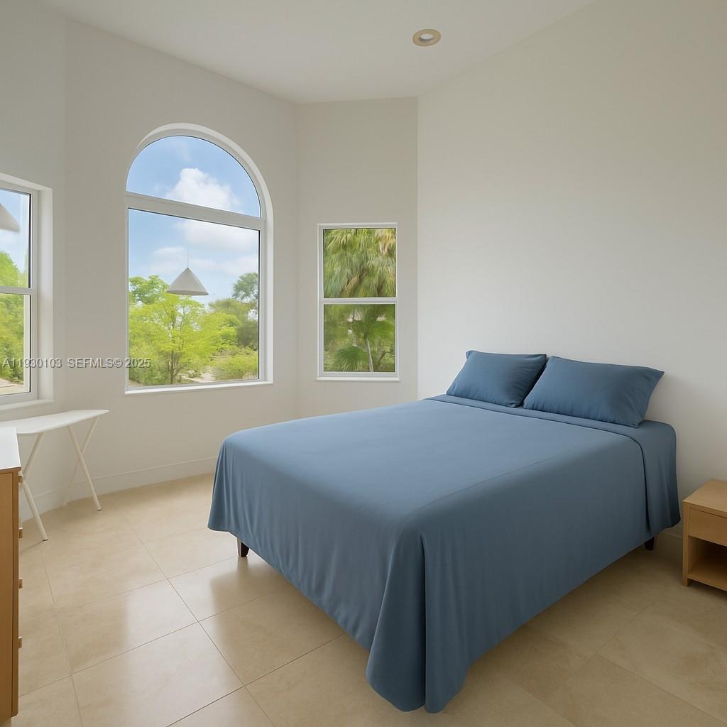 1490 Cleveland Road Miami Beach, FL 33141 - Photo 20 of 22 a bedroom with a bed and a painting on the wall