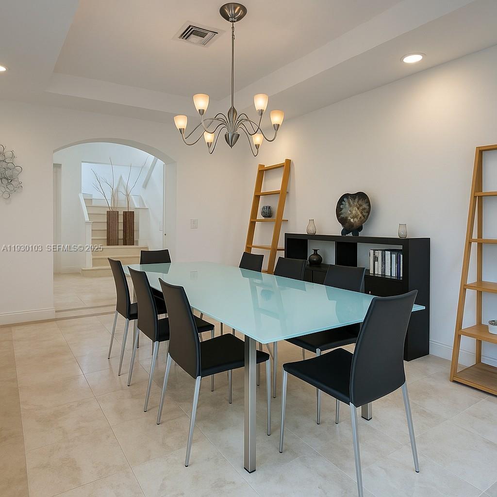 1490 Cleveland Road Miami Beach, FL 33141 - Photo 7 of 22 a view of a dining room with furniture and a chandelier