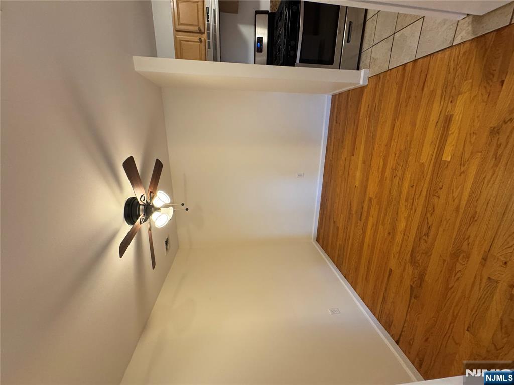 698 Undercliff Avenue Edgewater, NJ 07020 - Photo 3 of 10 a view of an empty room with a ceiling fan