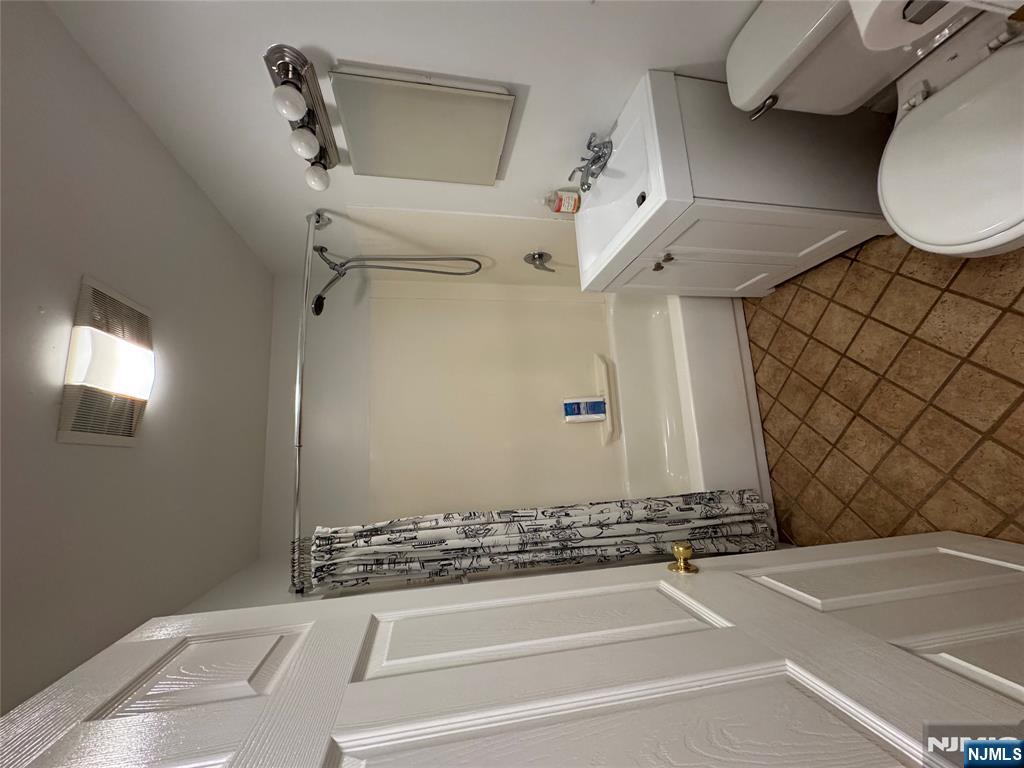 698 Undercliff Avenue Edgewater, NJ 07020 - Photo 6 of 10 a bathroom with a sink toilet and shower