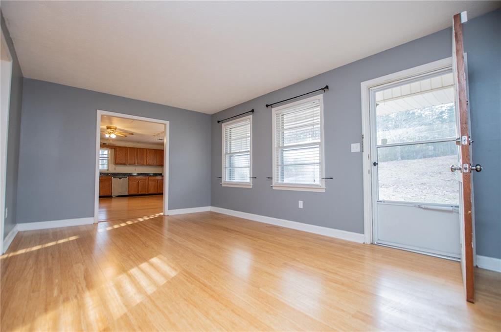 5166 Liberty Road Villa Rica, GA 30180 - Photo 12 of 52 a view of an empty room with a window and wooden floor
