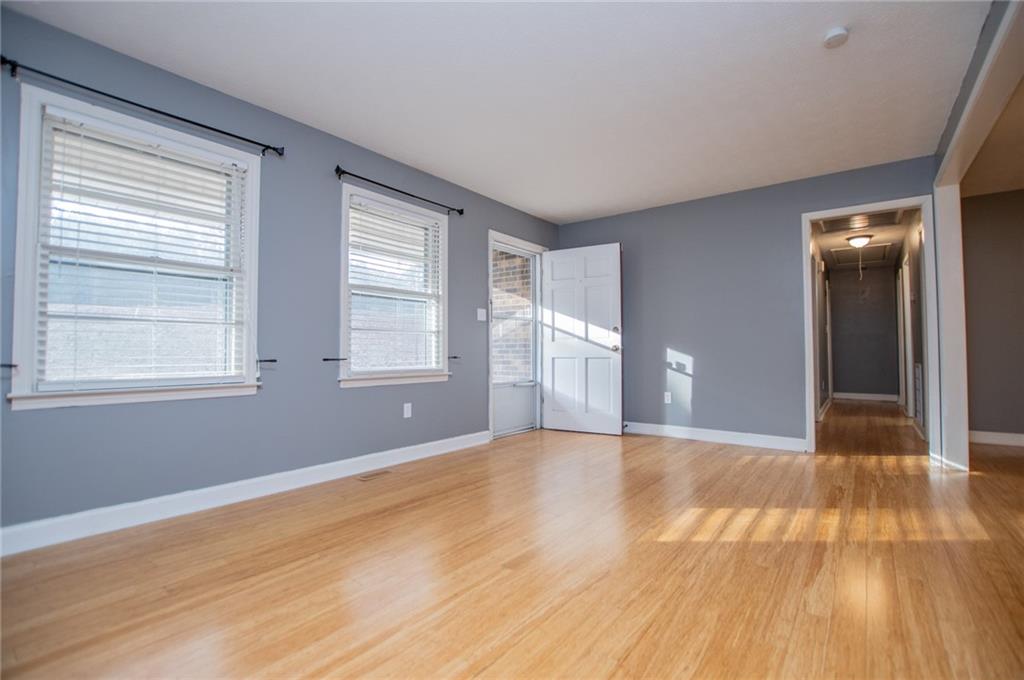 5166 Liberty Road Villa Rica, GA 30180 - Photo 13 of 52 a view of an empty room with wooden floor and a window