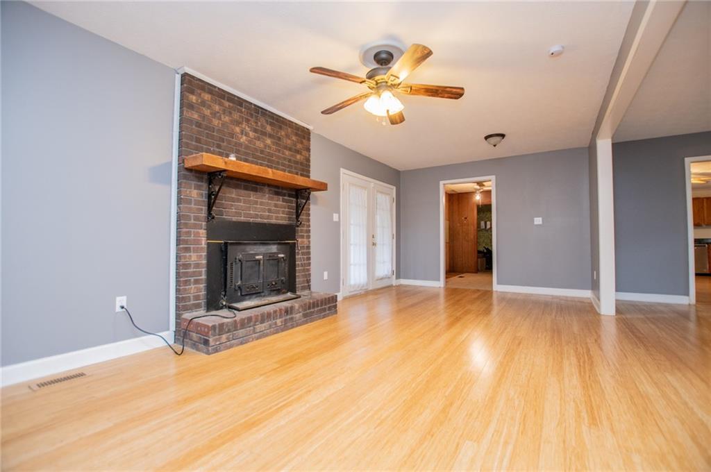 5166 Liberty Road Villa Rica, GA 30180 - Photo 20 of 52 a view of an empty room with wooden floor and a fireplace