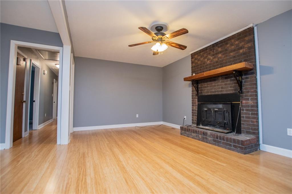 5166 Liberty Road Villa Rica, GA 30180 - Photo 21 of 52 a view of an empty room with wooden floor and a fireplace