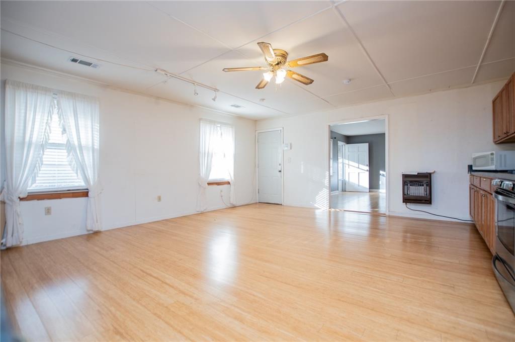 5166 Liberty Road Villa Rica, GA 30180 - Photo 22 of 52 a view of an empty room with window and wooden floor