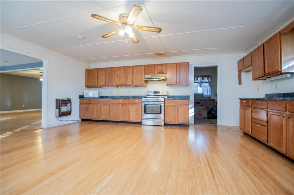 5166 Liberty Road Villa Rica, GA 30180 - Photo 26 of 52 a view of kitchen with stainless steel appliances granite countertop a stove top oven a sink and dishwasher with wooden floor