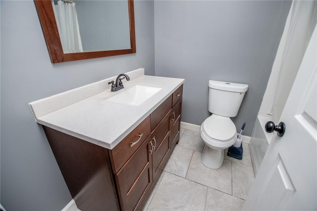 5166 Liberty Road Villa Rica, GA 30180 - Photo 33 of 52 a bathroom with a sink a toilet and mirror