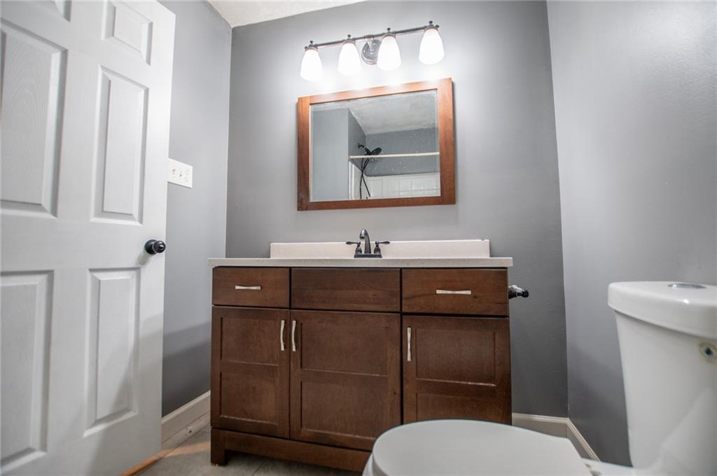 5166 Liberty Road Villa Rica, GA 30180 - Photo 35 of 52 a bathroom with a toilet a sink a vanity and mirror