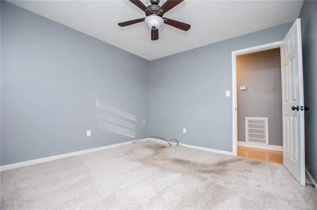 a view of a room with a ceiling fan