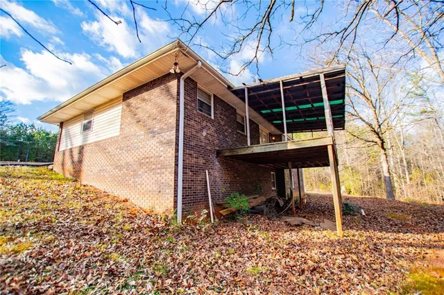 a view of a garage with wooden floor and fence